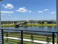 View of lake, community amenities, and houses at 3141 Paradox Cir # 306, Kissimmee, FL 34746