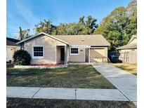 Cute and charming one-story home with a landscaped yard and driveway at 120 Lake Dr, Orlando, FL 32835