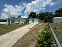 Light teal single-story house exterior at 812 Lily Ct, Deltona, FL 32725