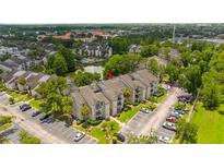 Apartment complex with a lake and ample parking at 1932 Lake Atriums Cir # 86, Orlando, FL 32839