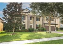 Two-story house with stone accents and a landscaped lawn at 319 Morning View Dr, Winter Garden, FL 34787