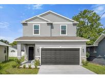 Two-story home with gray siding and a two-car garage at 1402 Persimmon Ave, Sanford, FL 32771