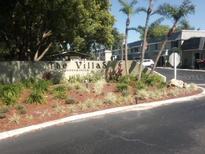 The Villas Condominium entrance with landscaping at 525 Conway Rd # 201, Orlando, FL 32807