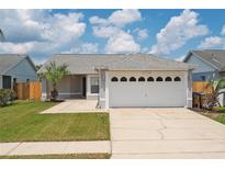 One story home with a two car garage and well maintained lawn at 4704 Cheyenne Point Trl, Kissimmee, FL 34746