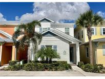 Modern two-story home with light gray exterior and palm trees at 8125 Surf St, Kissimmee, FL 34747