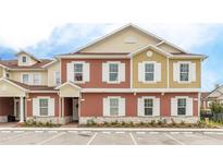 Modern two-story townhome with neutral color palette and guest parking at 7525 Sunflower Cir, Kissimmee, FL 34747
