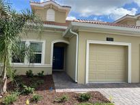 House exterior featuring a two-car garage at 1133 Trappers Trail Loop, Champions Gate, FL 33896