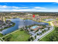 Aerial view of a house community with lake, pool, and clubhouse at 2541 Seggolia Ln, Kissimmee, FL 34741