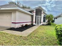 House exterior showcasing the front entrance and landscaping at 5610 King James Ave, Leesburg, FL 34748