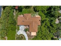 Aerial view of a single-Gathering home with a large lot and mature trees at 10611 Jim Edwards Rd, Haines City, FL 33844