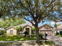 One-story home with mature landscaping and large trees at 898 Arbormoor Pl, Lake Mary, FL 32746