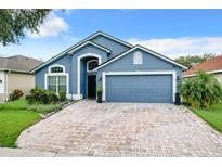 Two-car garage and paver driveway at 13333 Early Frost Cir, Orlando, FL 32828