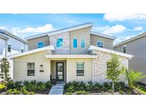 Modern two-story home with stone accents and landscaping at 2965 Protagonist St, Kissimmee, FL 34746