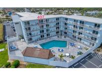 Aerial view of condo building, pool, and unit #407 at 3700 S Atlantic Ave # 407, New Smyrna Beach, FL 32169