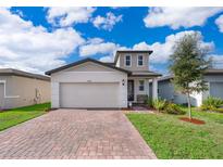 Two-story house with a modern facade and landscaped yard at 2370 Brassie Ct, Winter Haven, FL 33884