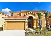Two-story house with tan exterior and double garage at 401 Cabello Dr, Davenport, FL 33837