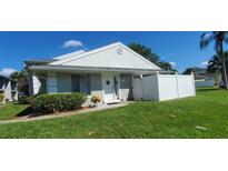 Exterior view of a light gray house with white trim and a neatly landscaped yard at 4367 White Pine Ave # 4, Orlando, FL 32811