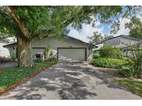 Two-car garage with mature landscaping at 2035 Lake Alden Dr # Ge, Apopka, FL 32712