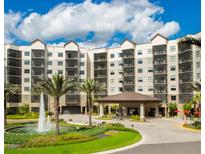 Multi-story building with a fountain and covered entrance at 14501 Grove Resort Ave # 3137, Winter Garden, FL 34787