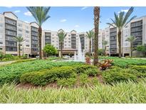 Building exterior with lush landscaping and fountain at 14501 Grove Resort Ave # 3229, Winter Garden, FL 34787