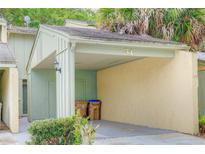 Covered carport with space for one vehicle and extra storage at 34 Saint Andrews Ct, Kissimmee, FL 34759