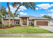 Brick home with landscaped yard, two-car garage, and inviting entryway at 250 Shady Oaks Cir, Lake Mary, FL 32746