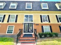 Exterior view of a two-story building with a central entrance at 3970 Versailles Dr # 3970B, Orlando, FL 32808
