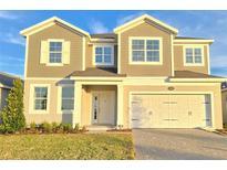 Two-story house with beige siding, white trim, and a two-car garage at 2645 Bittern Bnd, Saint Cloud, FL 34771