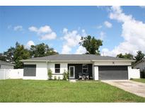 Modern two-bedroom house with gray and white exterior at 1148 Bancroft St, Deltona, FL 32725