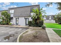 Two-unit building exterior, showcasing a shared parking area and landscaping at 1930 Conway Rd # 6, Orlando, FL 32812