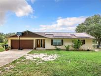 Ranch style home with solar panels, double garage, and basketball court at 2405 Boy Scout Rd, Apopka, FL 32703