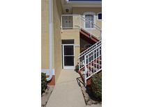 Exterior view of condo building showing entrance and staircase at 14102 Indian Creek Dr, Kissimmee, FL 34759