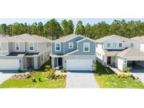 Community of two-story houses with gray and white exteriors at 4458 Kaipo Rd, Davenport, FL 33897