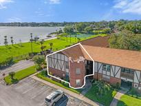 Brick condo building near lake and tennis courts at 5437 Hansel Ave # J10, Orlando, FL 32809