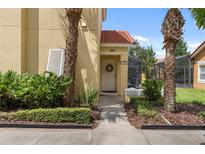 Inviting townhouse entrance with lush landscaping and a charming wreath at 126 Pompano Beach Dr, Kissimmee, FL 34746