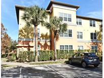 Tan building exterior with palm trees and parking at 5467 Vineland Rd # 6308, Orlando, FL 32811