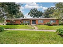 Brick ranch home with landscaped lawn and walkway at 1330 Webster St, Orlando, FL 32804