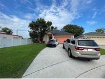 House with two cars parked in driveway at 4336 Cypress Bay Ct, Orlando, FL 32822