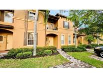Townhouse exterior with walkway and landscaping at 2214 Calabria Ave, Davenport, FL 33897
