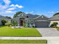 One-story house with a gray exterior and a two-car garage at 4814 Terra Sole Pl, St Cloud, FL 34771