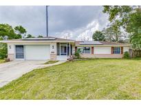 House exterior with solar panels and a spacious yard at 1522 Gainesville Dr, Deltona, FL 32725