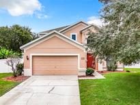 Two-story house with attached garage and manicured lawn at 431 Balboa Blvd, Clermont, FL 34715