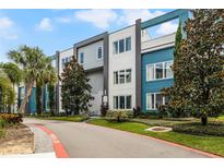 Modern building exterior with teal and gray accents at 7770 Sandy Ridge Dr # 208, Reunion, FL 34747