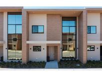 Modern townhome exterior with large windows and neutral colors at 7527 Brooklyn Dr # 7527, Kissimmee, FL 34747