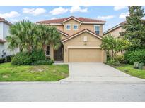 Two-story house with tan exterior, tile roof, and palm trees at 5229 Oakbourne Ave, Davenport, FL 33837