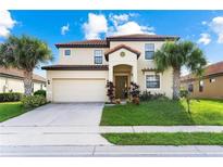Two-story house with tan exterior, tile roof and landscaping at 2654 Rosemont Cir, Davenport, FL 33837
