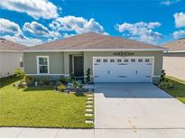 Single-story house with two-car garage and landscaping at 1475 Haines Dr, Winter Haven, FL 33881