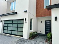 Modern home exterior with brick and glass garage door at 1917 S Lakemont Ave, Winter Park, FL 32792