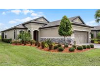 One-story home with attractive landscaping and a two-car garage at 919 Braewood Dr, Clermont, FL 34715