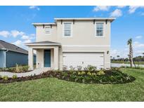 Two-story house with light beige exterior and a white garage door at 2888 Waterlily Way, Poinciana, FL 34759